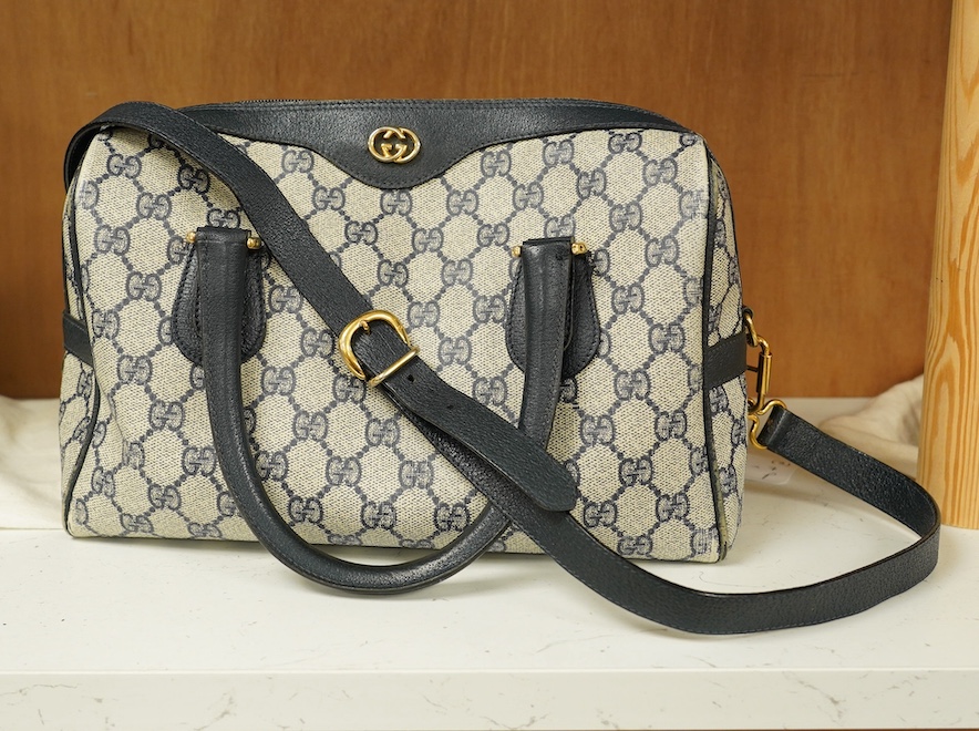 A Gucci monogram blue canvas handbag, wallet and purse